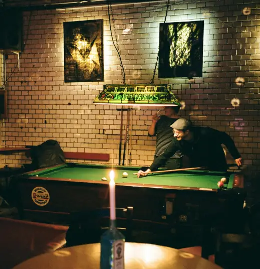 pool table with person shooting at it